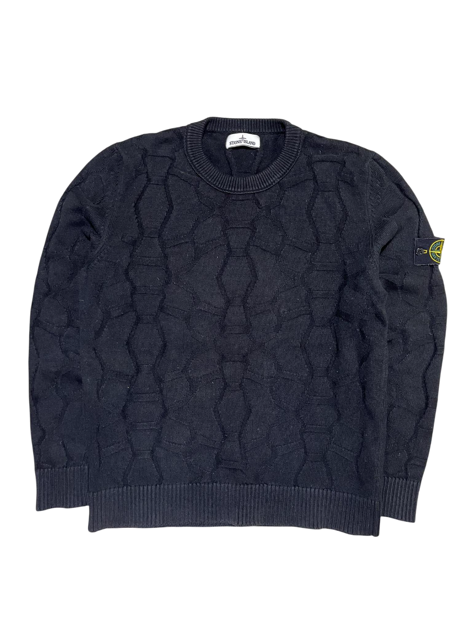 Fekete kötött pulóver jellegzetes mintával, karon logós felvarróval, streetwear stílusban.
